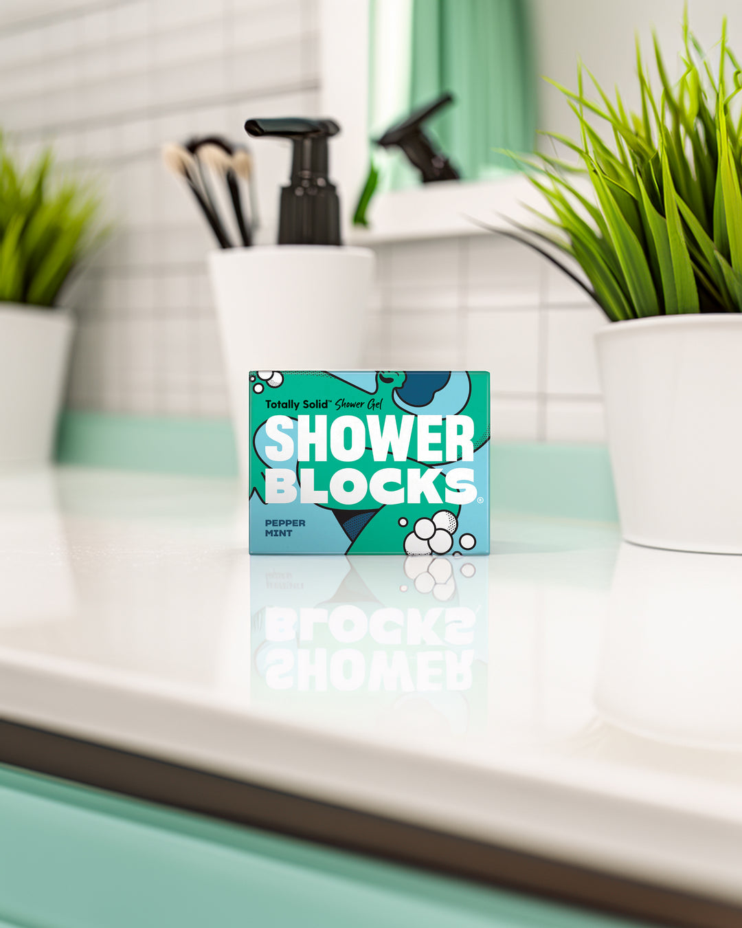 Box of Shower Blocks on a bathroom counter with plants and a sink in the background