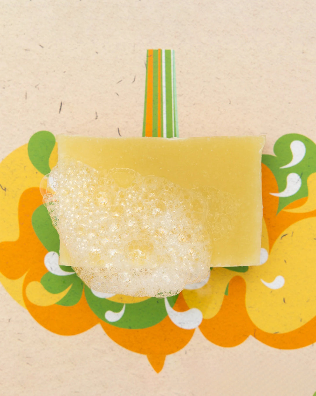 Yellow sponge with bubbles on a decorative background