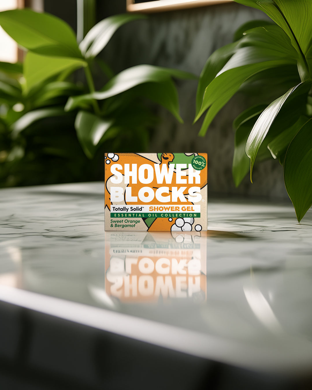 Box of Shower Blocks on a marble surface with green plants in the background
