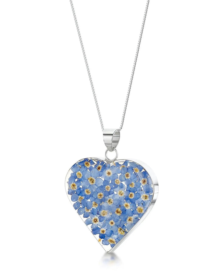 Heart-shaped pendant with floral design on a white background