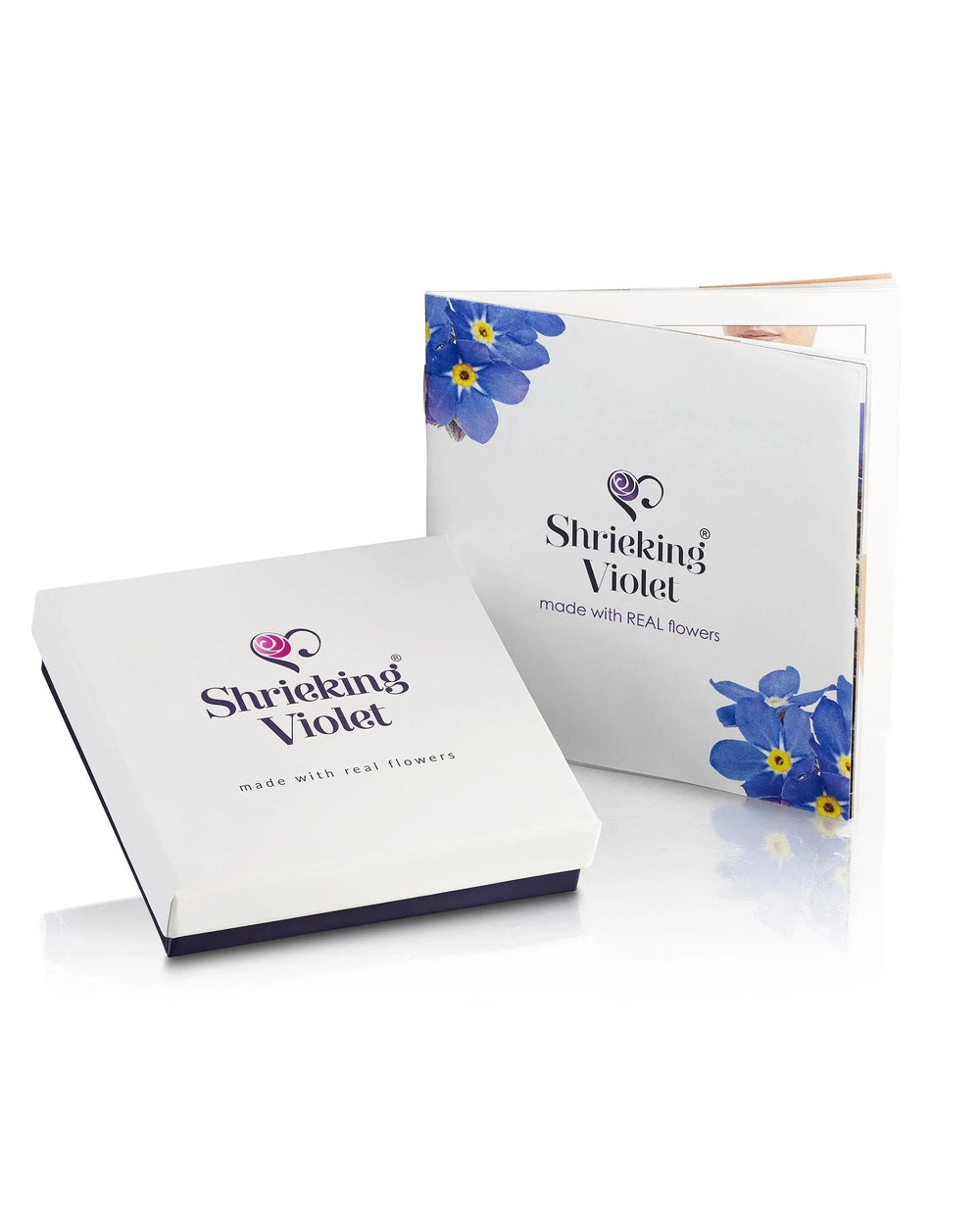 Two boxes of 'Shrinking Violet' with blue flowers on a white background