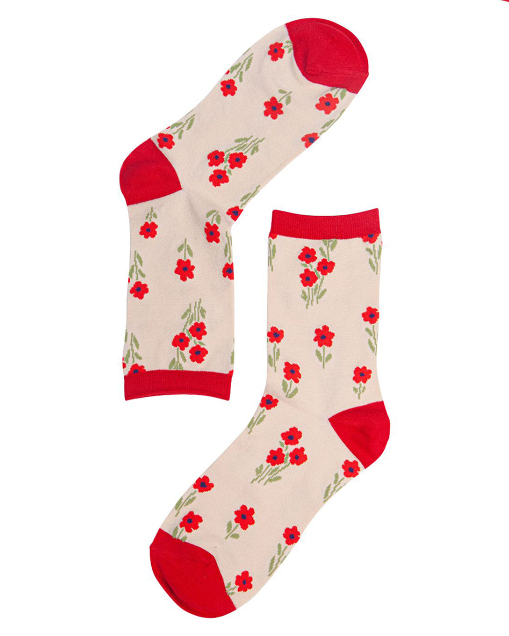 Pair of socks with red floral pattern on a beige background