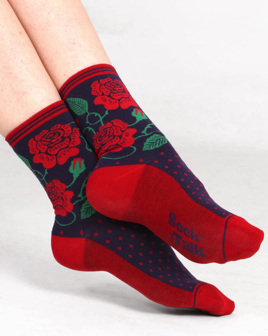 Red and blue socks with floral design on a white background