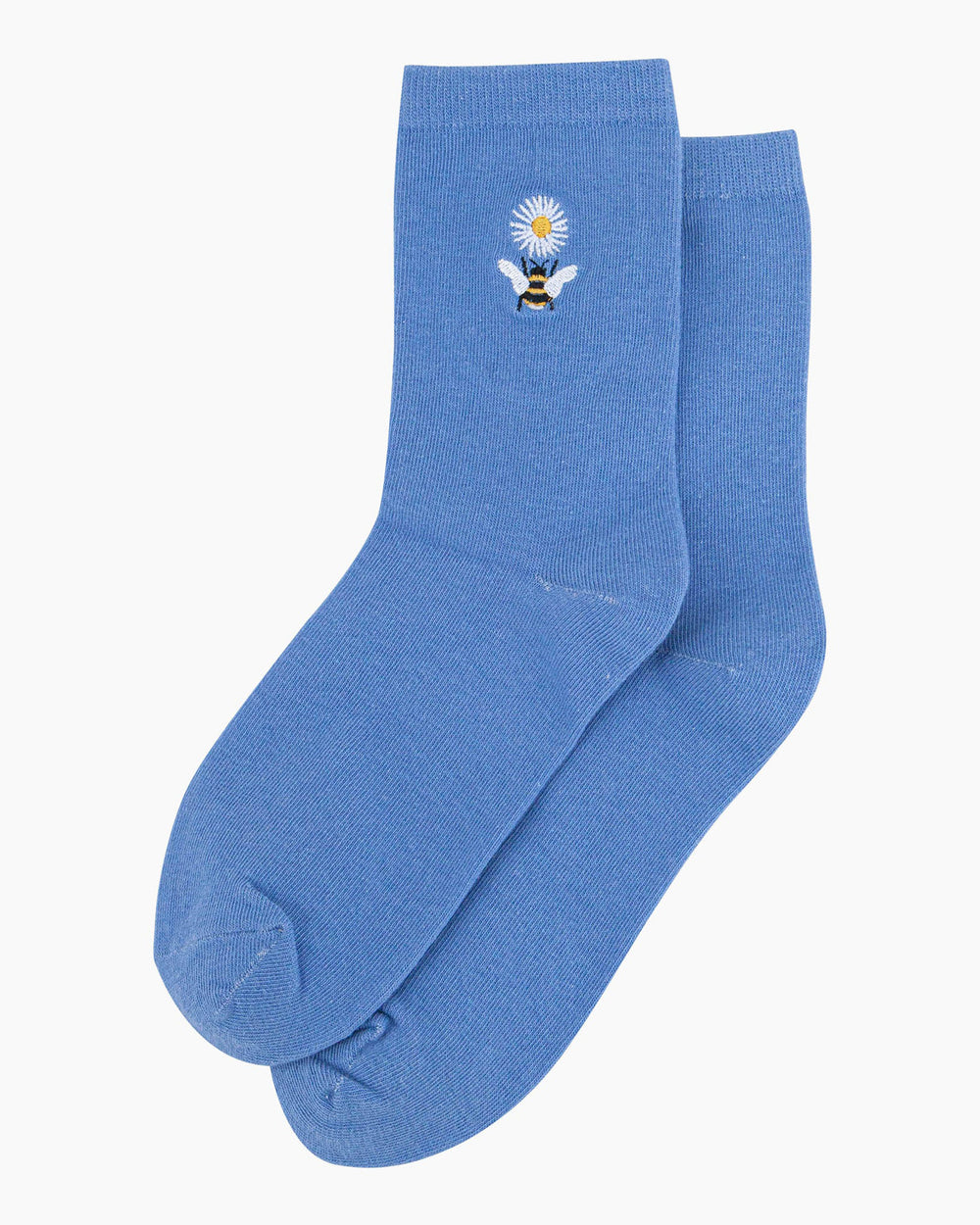Blue socks with a bee and flower design on a white background