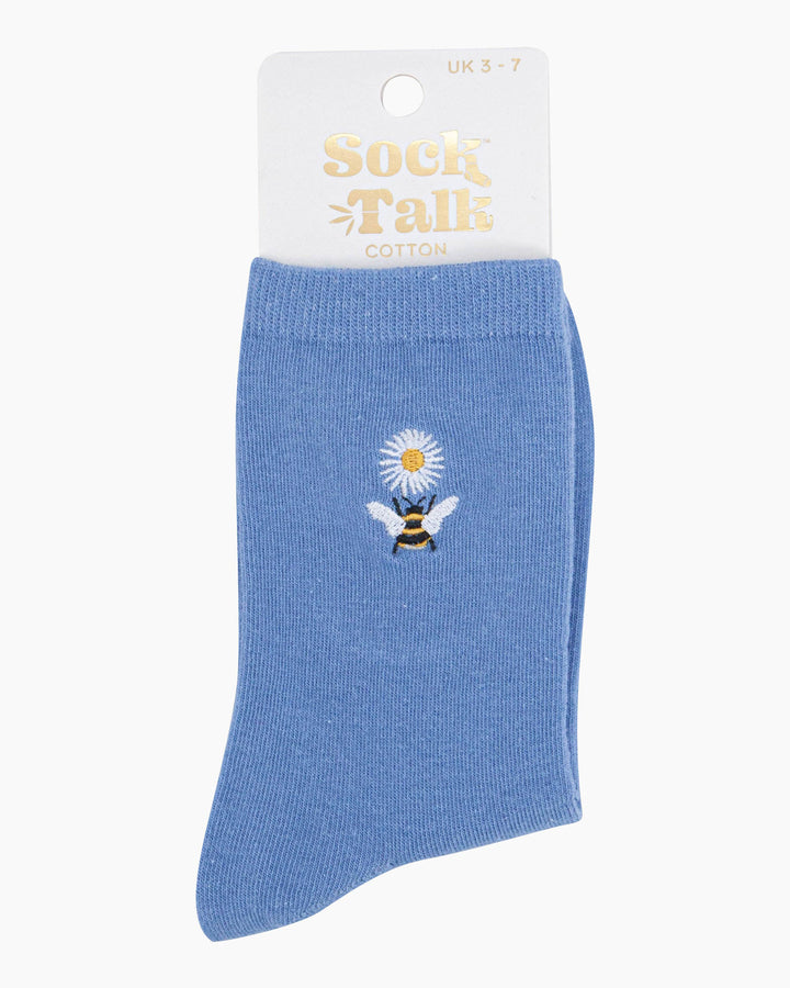 Blue sock with bee and flower design on packaging labeled 'Sock Talk'.