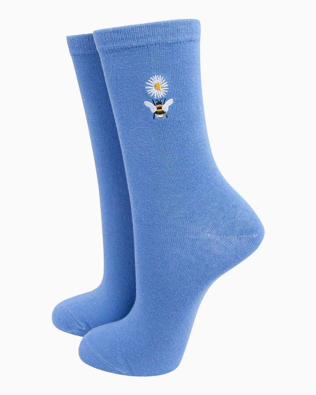 Pair of blue socks with a bee and flower design on a white background