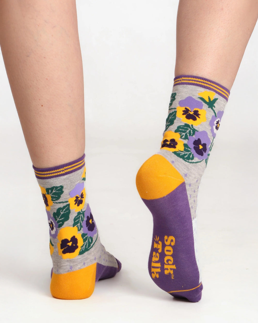 Colorful floral-patterned socks with purple and yellow accents on a white background