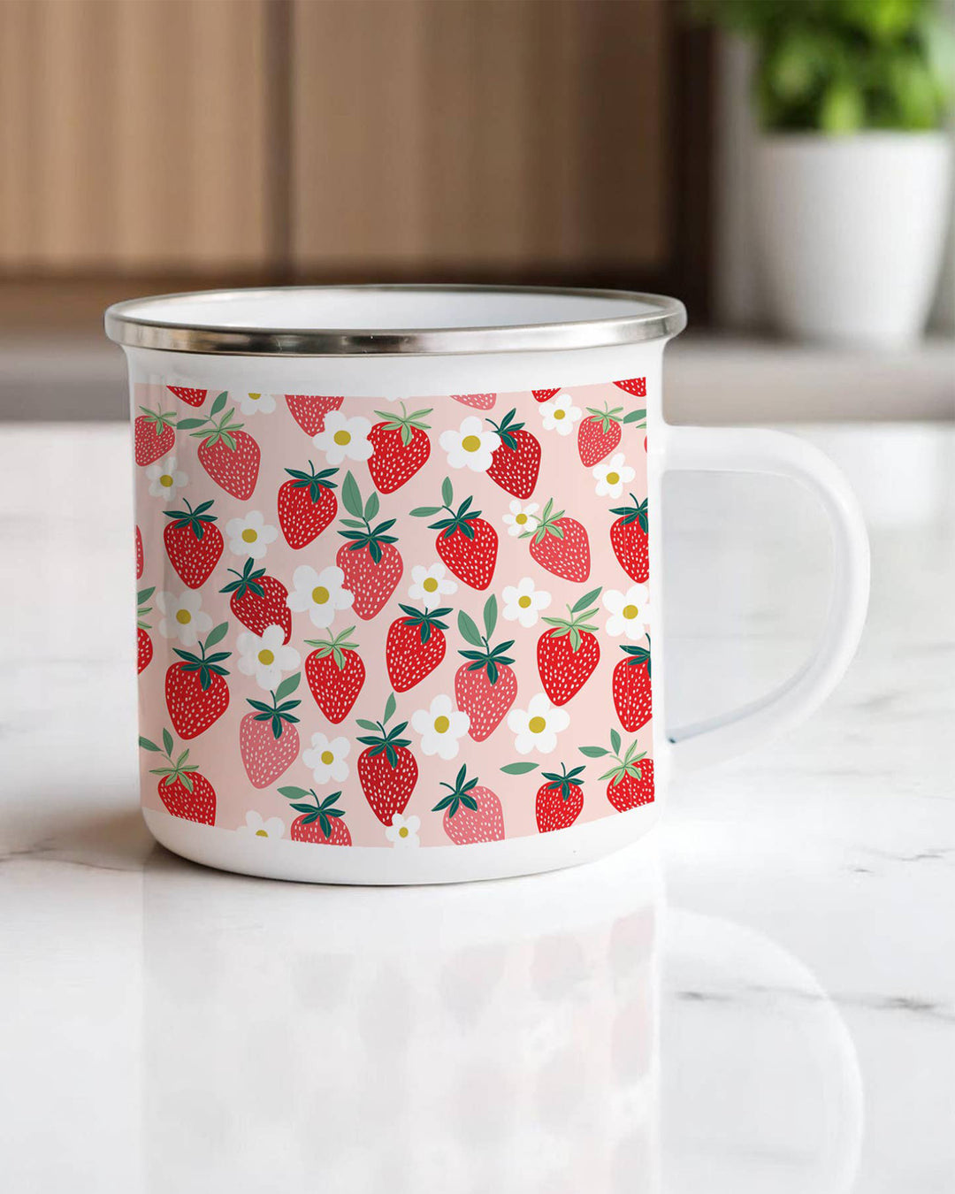 Enamel mug with strawberry pattern on a white surface