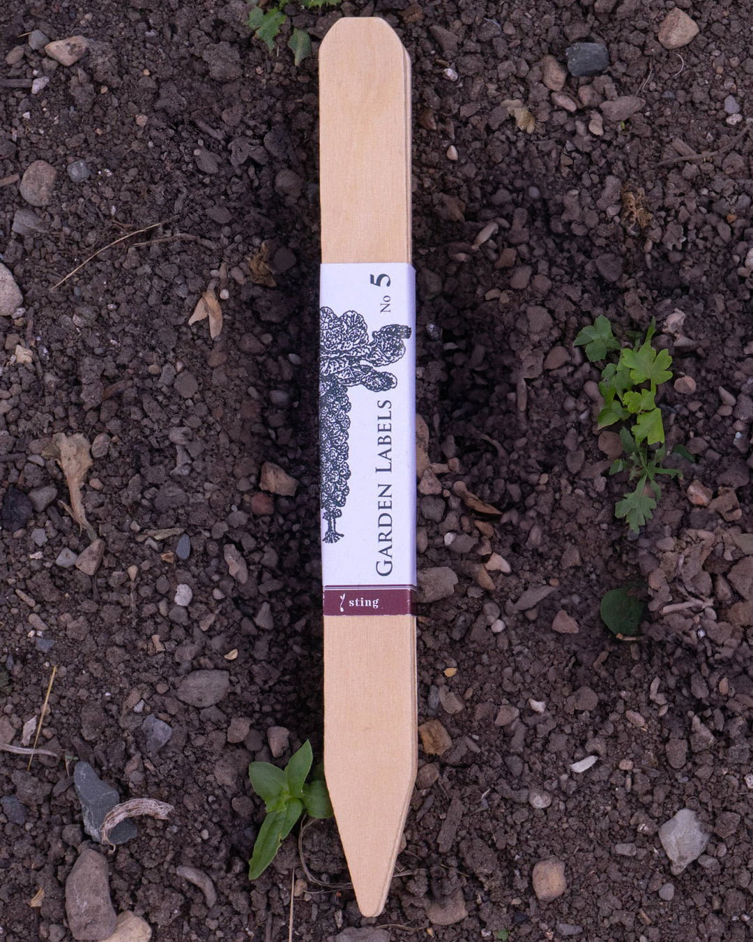 Garden label on soil with visible brand name
