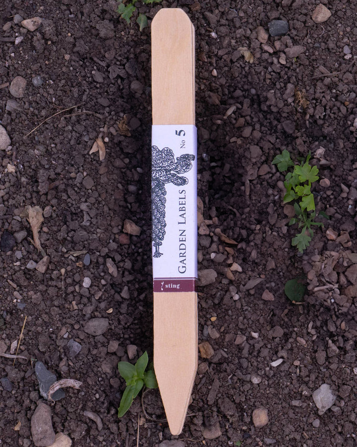 Garden label on soil with visible brand name