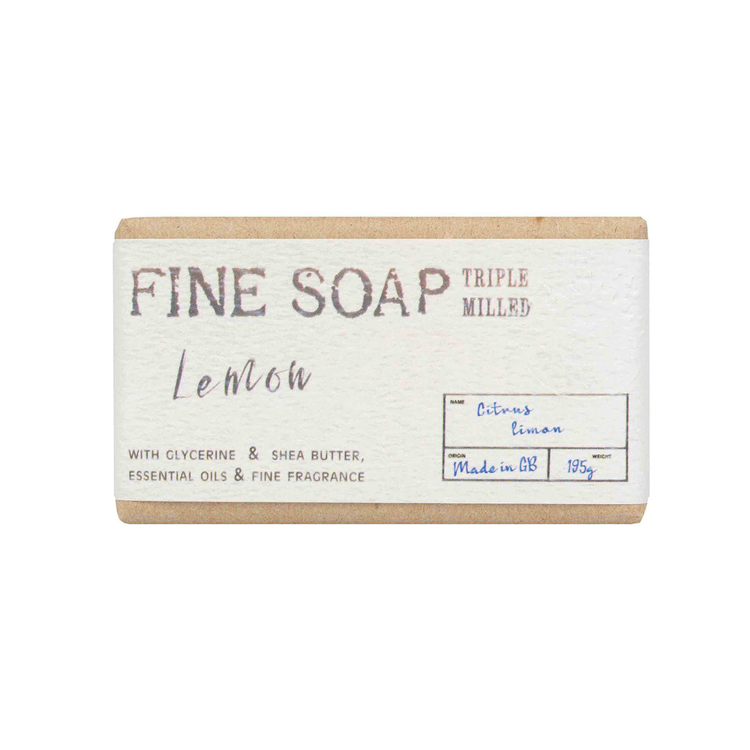 Bar of lemon-scented soap with a white label on a white background