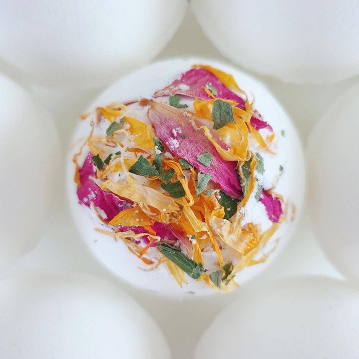 Decorative salt cellar with colorful herbs on a white background