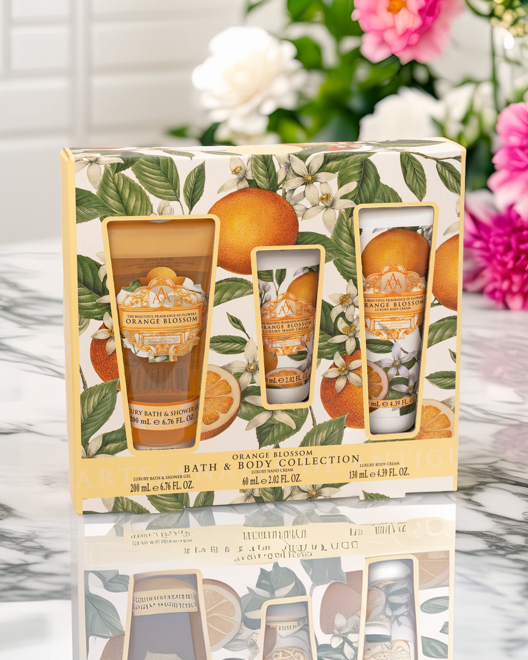 Orange Blossom bath and body collection packaging with floral and fruit design.