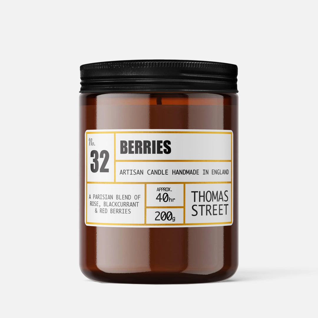 Brown candle jar with black lid and label on a white background