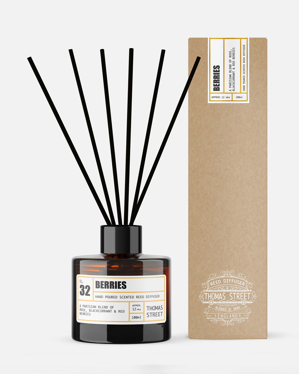 Diffuser with black sticks and a Thomas Street label next to its packaging on a white background