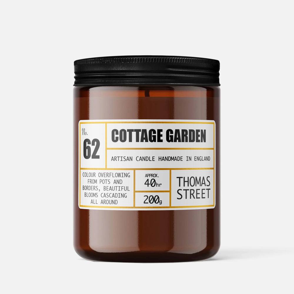 Candle labeled 'Cottage Garden' by Thomas Street on a white background