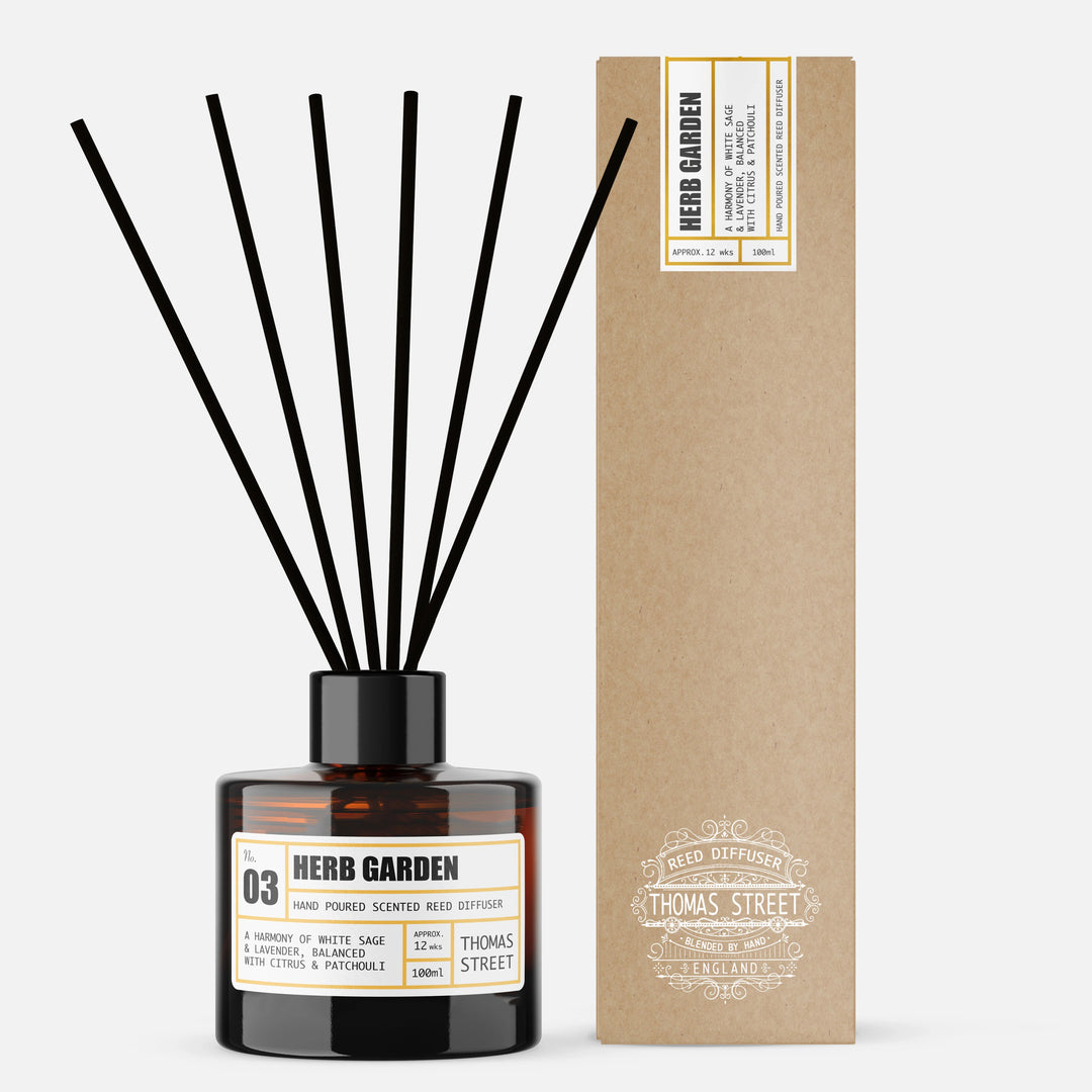 Reed diffuser labeled 'Herb Garden' with a matching cardboard box on a white background