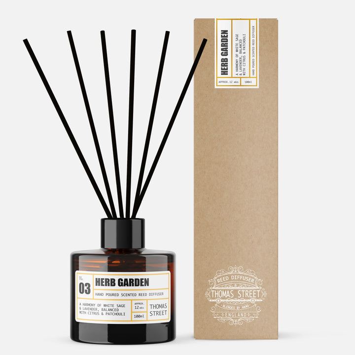Reed diffuser labeled 'Herb Garden' with a matching cardboard box on a white background