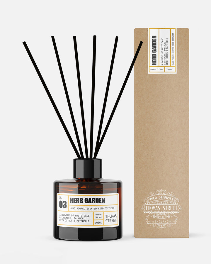 Diffuser bottle labeled 'Herb Garden' with black sticks and a matching box on a white background