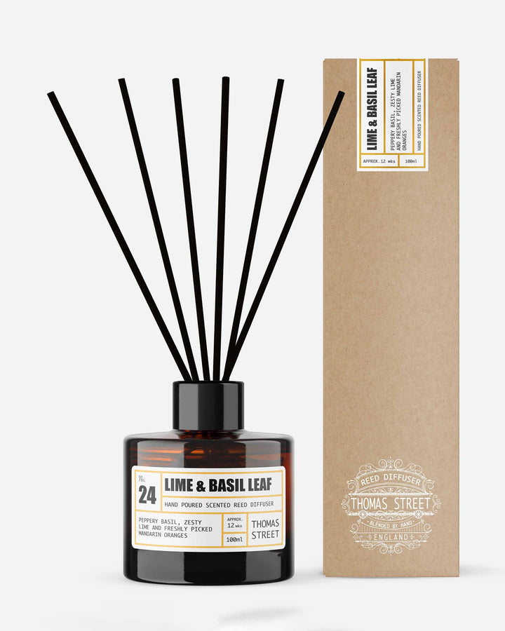 Diffuser with black sticks and a box labeled 'Lime & Basil Leaf' on a white background
