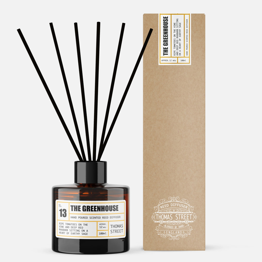 Reed diffuser with black sticks and a cardboard box labeled 'The Greenhouse' on a white background.