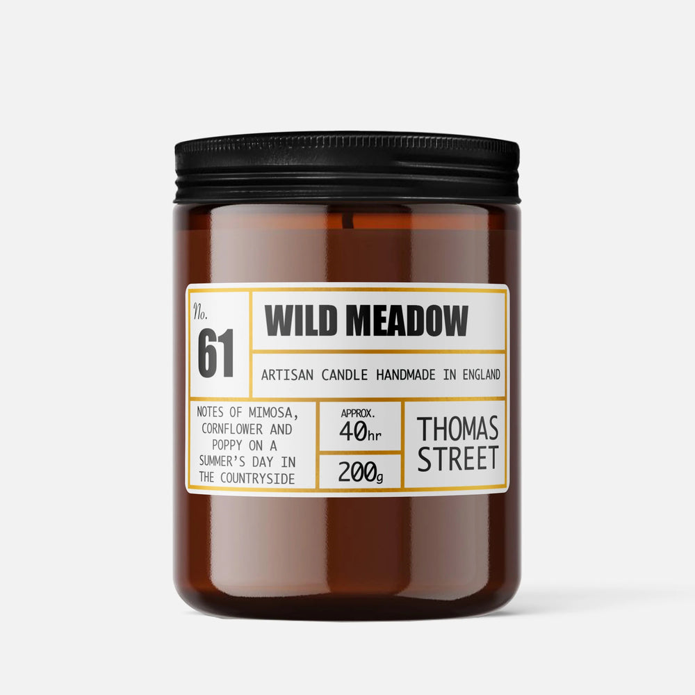 Candle labeled 'Wild Meadow' by Thomas Street on a white background