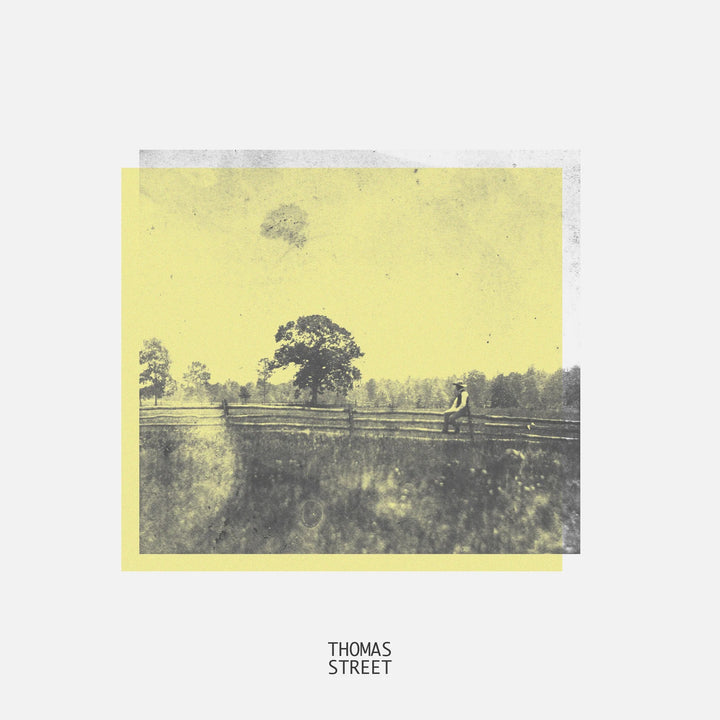 Album cover with a person sitting on a fence in a field, labeled 'Thomas Street'.