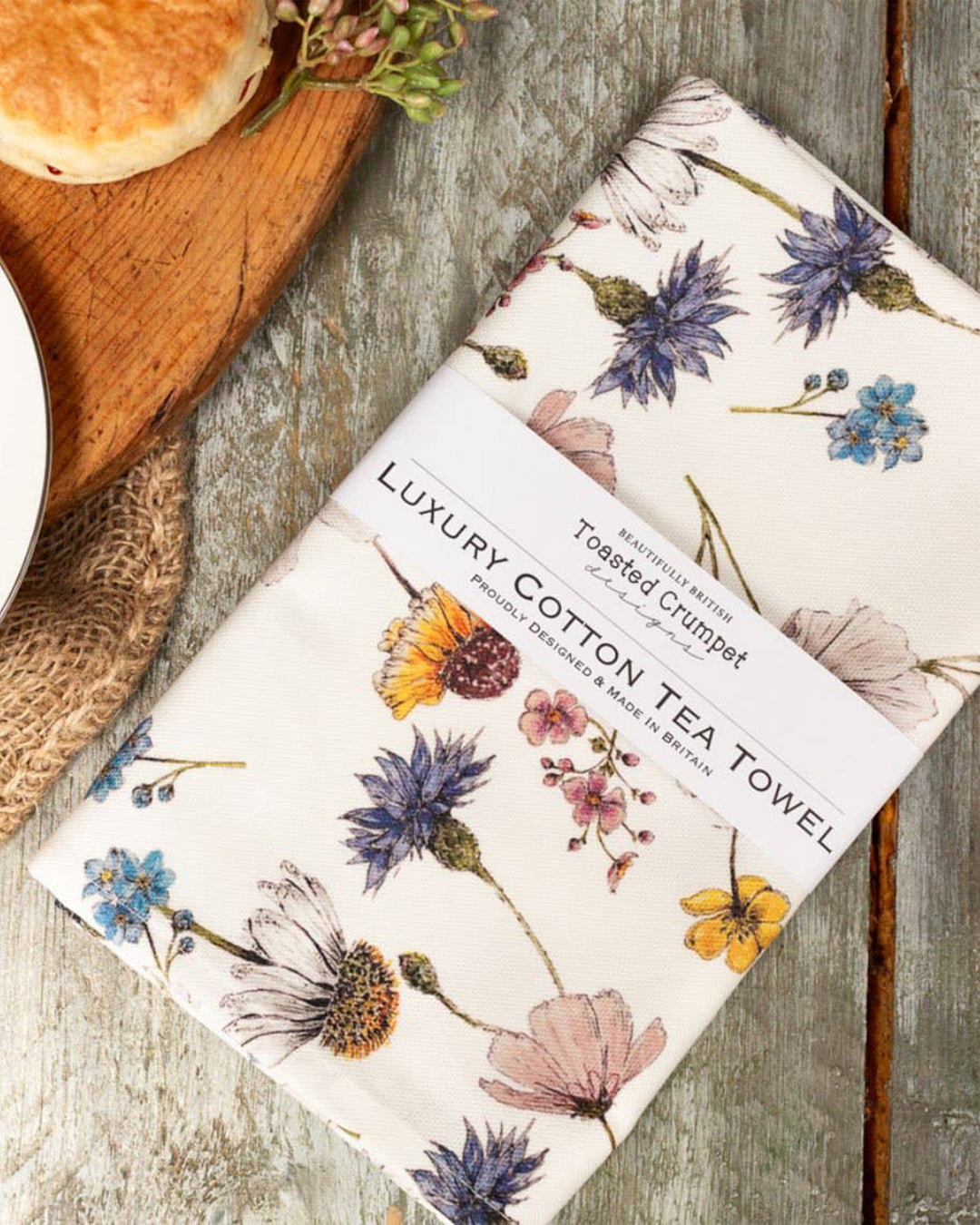 Tea towel with floral design on a wooden surface