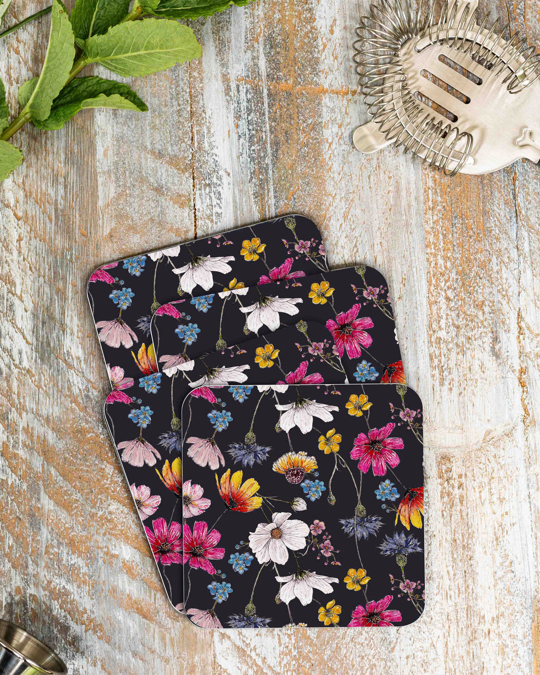 Set of floral coasters on a wooden surface with decorative elements.