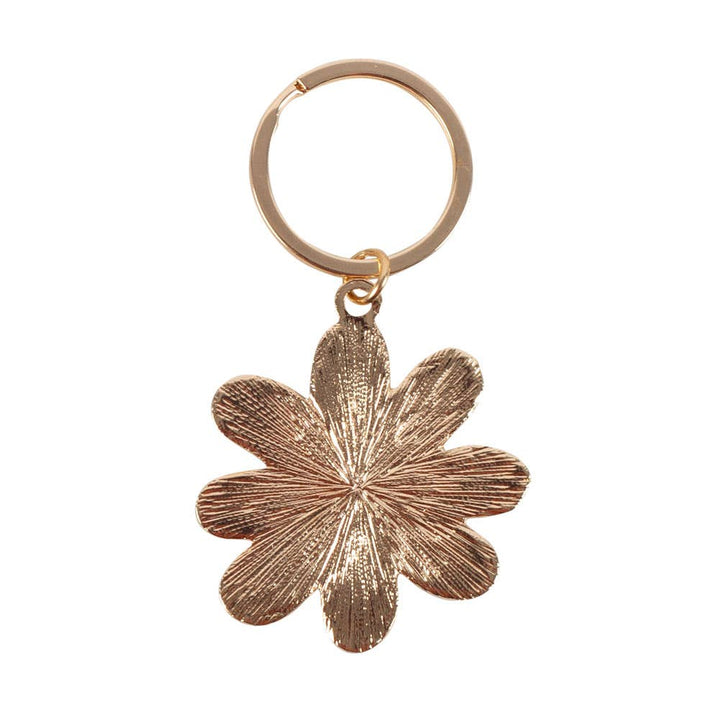 Rose gold flower-shaped keychain on a white background