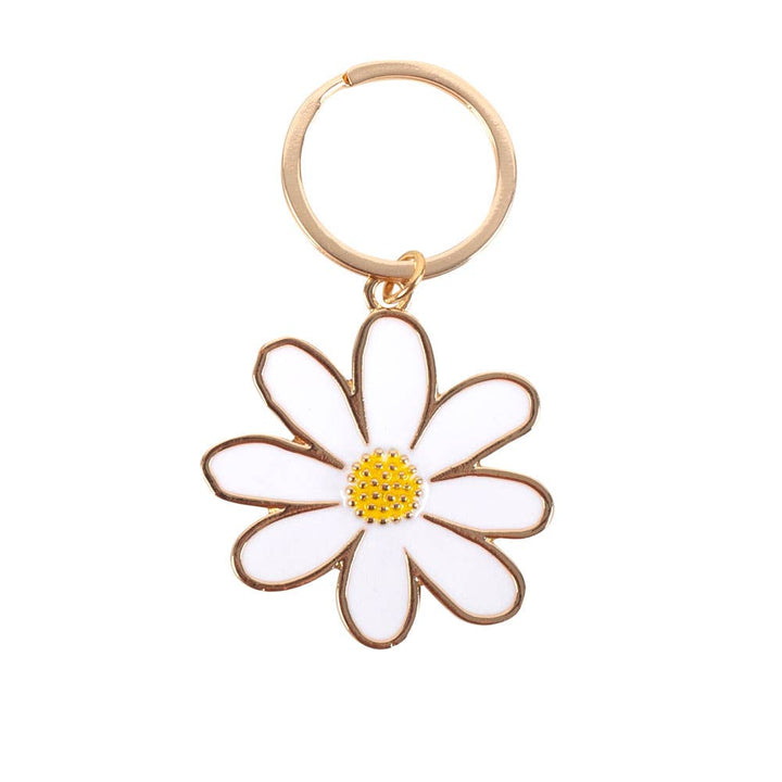 Daisy-shaped keychain with gold frame and yellow center on a white background