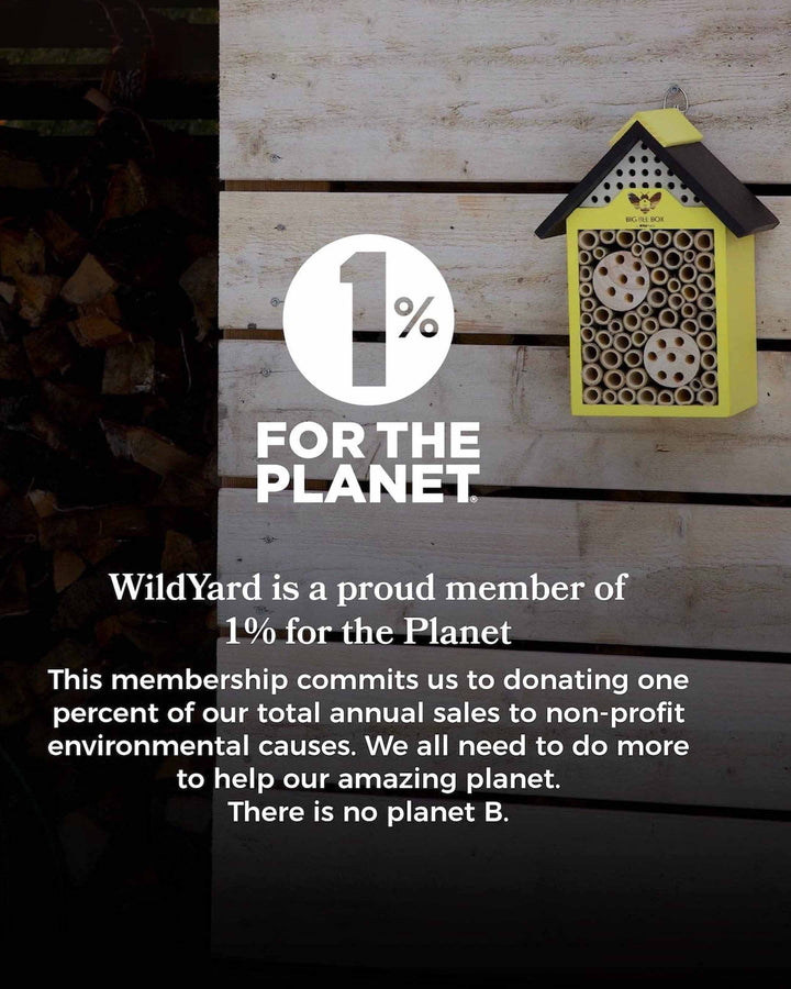 Bee house on a wooden background with '1% for the Planet' text and WildYard logo.