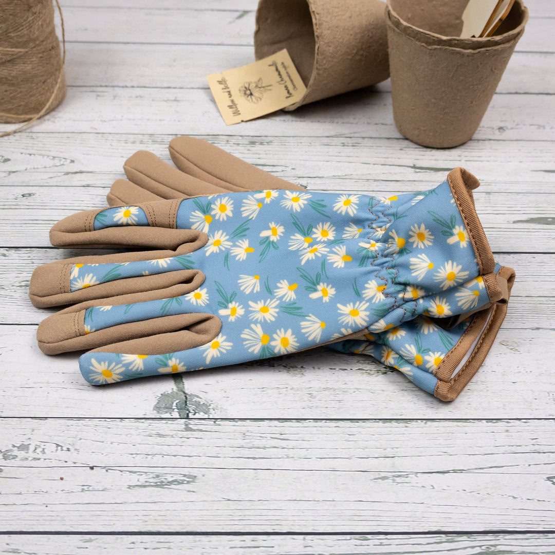 Gardening gloves with floral pattern on a wooden surface