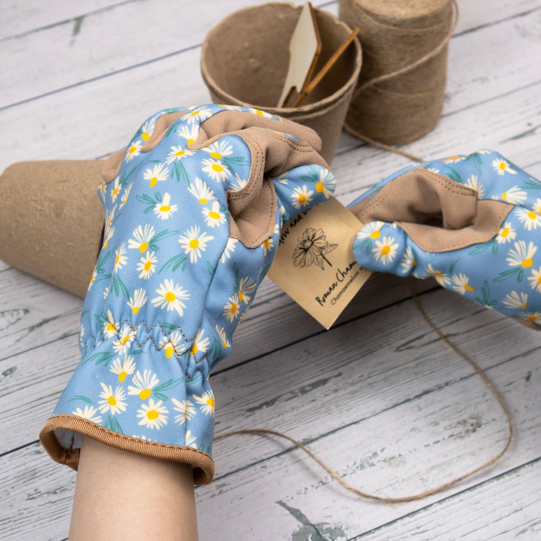 Gardening gloves with floral pattern on a wooden surface