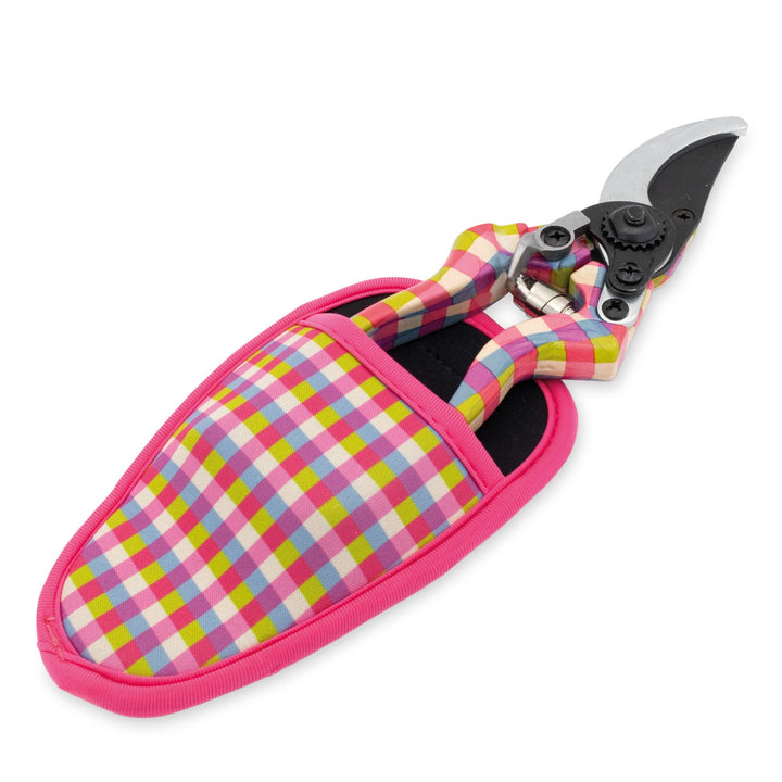 Gardening shears with a colorful checkered handle and pink sheath on a white background