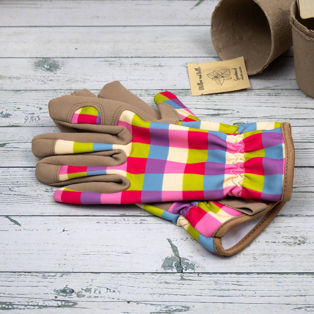 Colorful checkered gloves with brown accents on a wooden surface