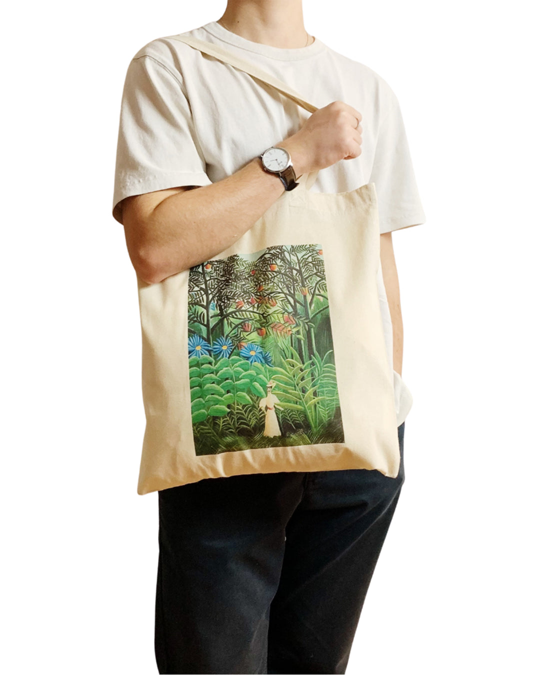 Person holding a tote bag with a forest design on a white background