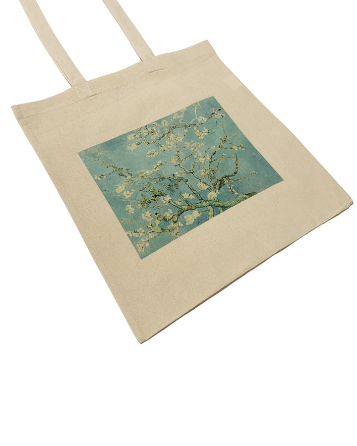 Beige tote bag with a square design of almond branches on a white background