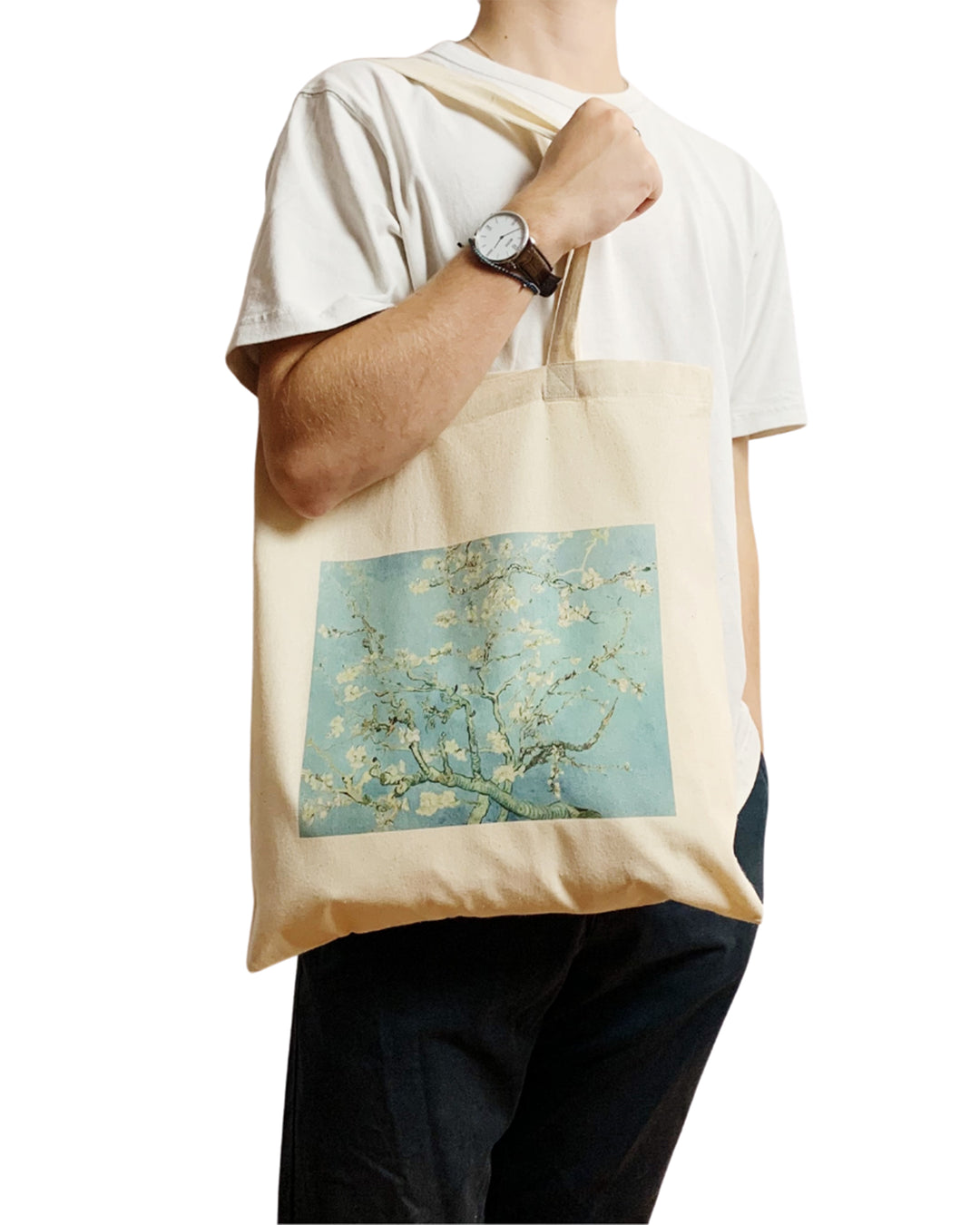 Person holding a tote bag with a floral design on a white background